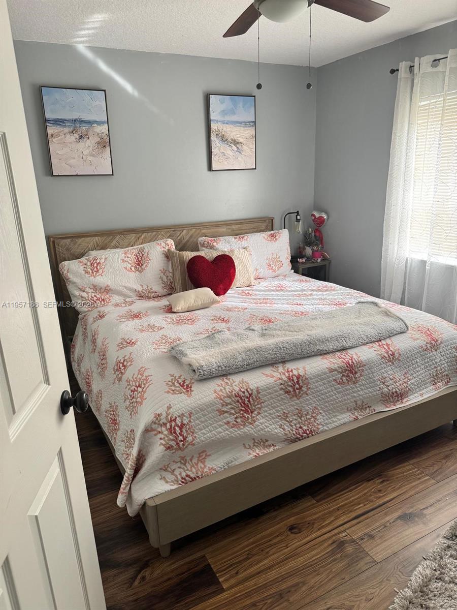 2931 Southeast 12th Road, Unit 10555 Homestead, FL 33035 - Photo 13 of 21 a large bed sitting in a bedroom chandelier