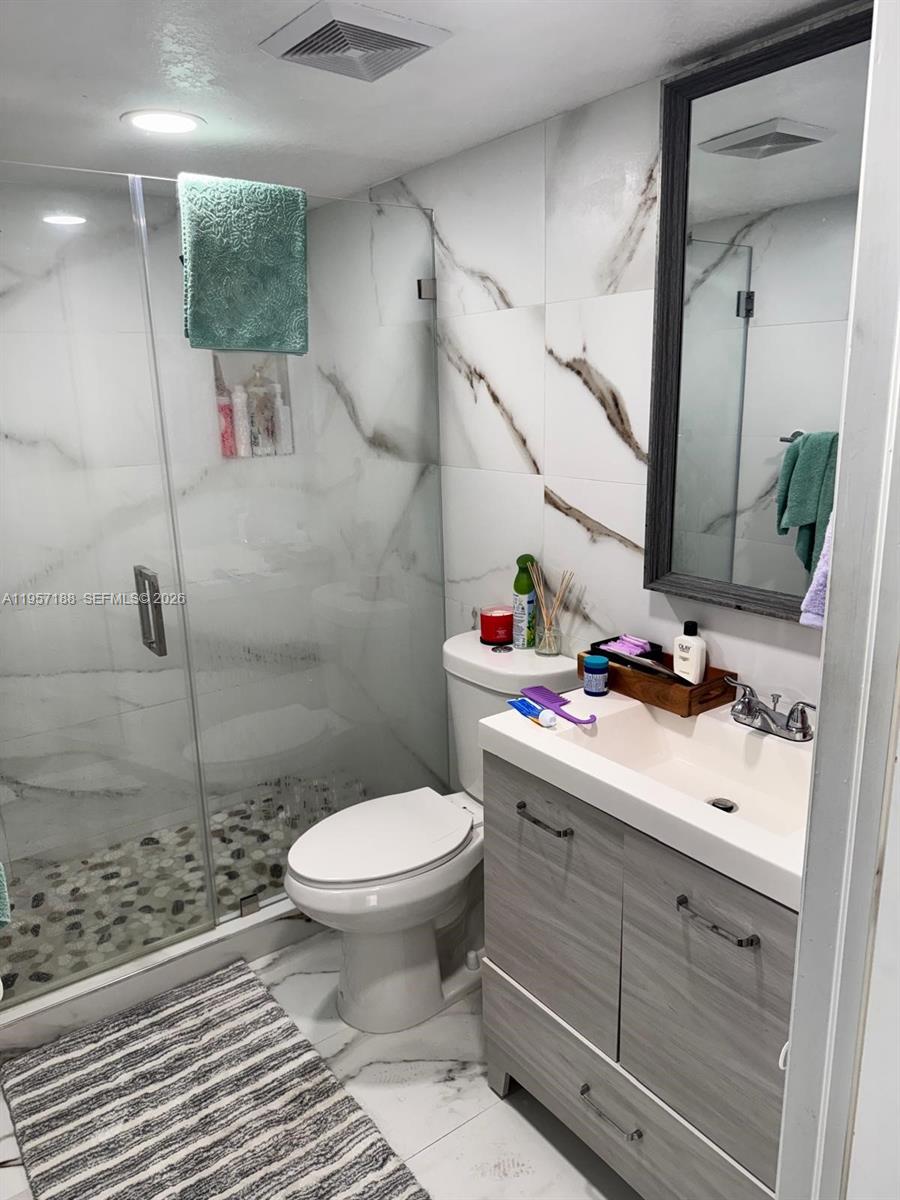 2931 Southeast 12th Road, Unit 10555 Homestead, FL 33035 - Photo 14 of 21 a bathroom with a sink toilet and shower