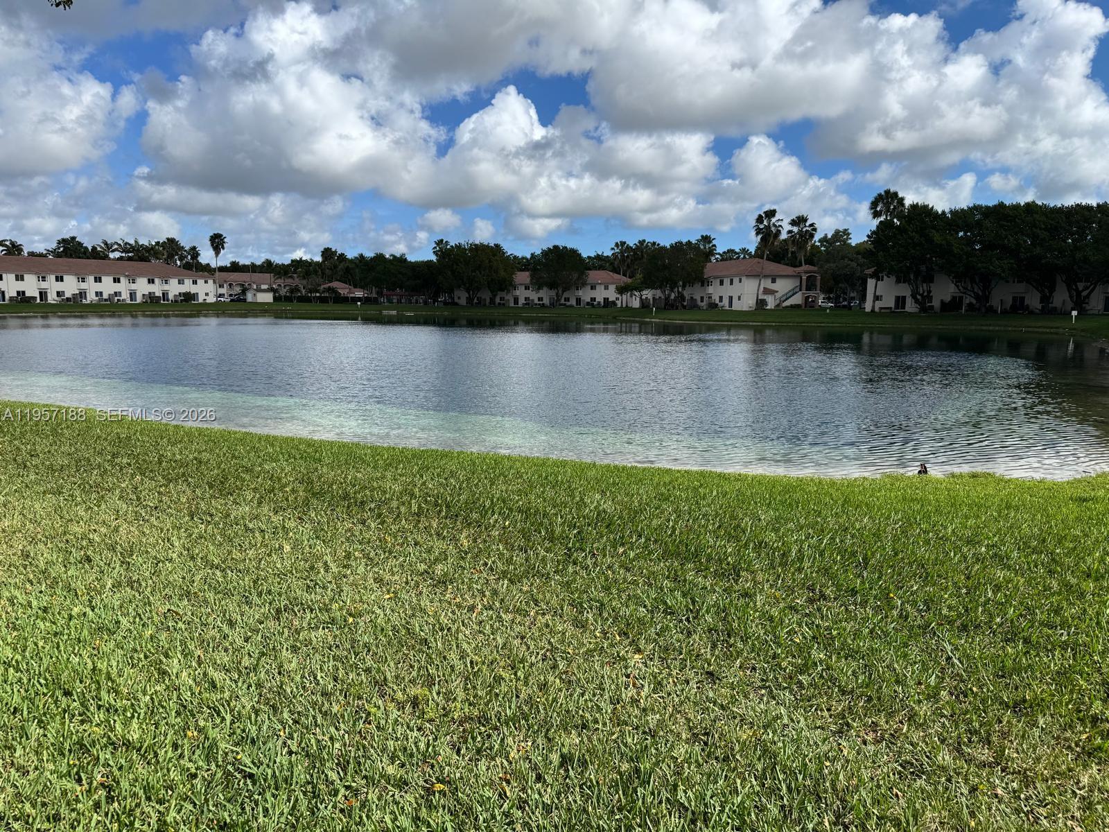 2931 Southeast 12th Road, Unit 10555 Homestead, FL 33035 - Photo 15 of 21 a view of a lake with houses in the back