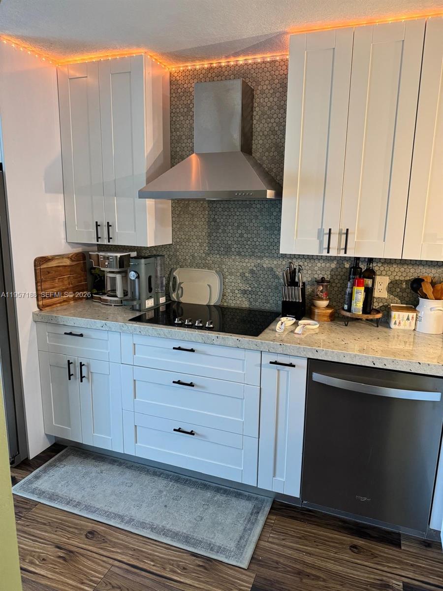 2931 Southeast 12th Road, Unit 10555 Homestead, FL 33035 - Photo 3 of 21 a kitchen with stainless steel appliances granite countertop a sink a stove and a microwave oven with cabinets