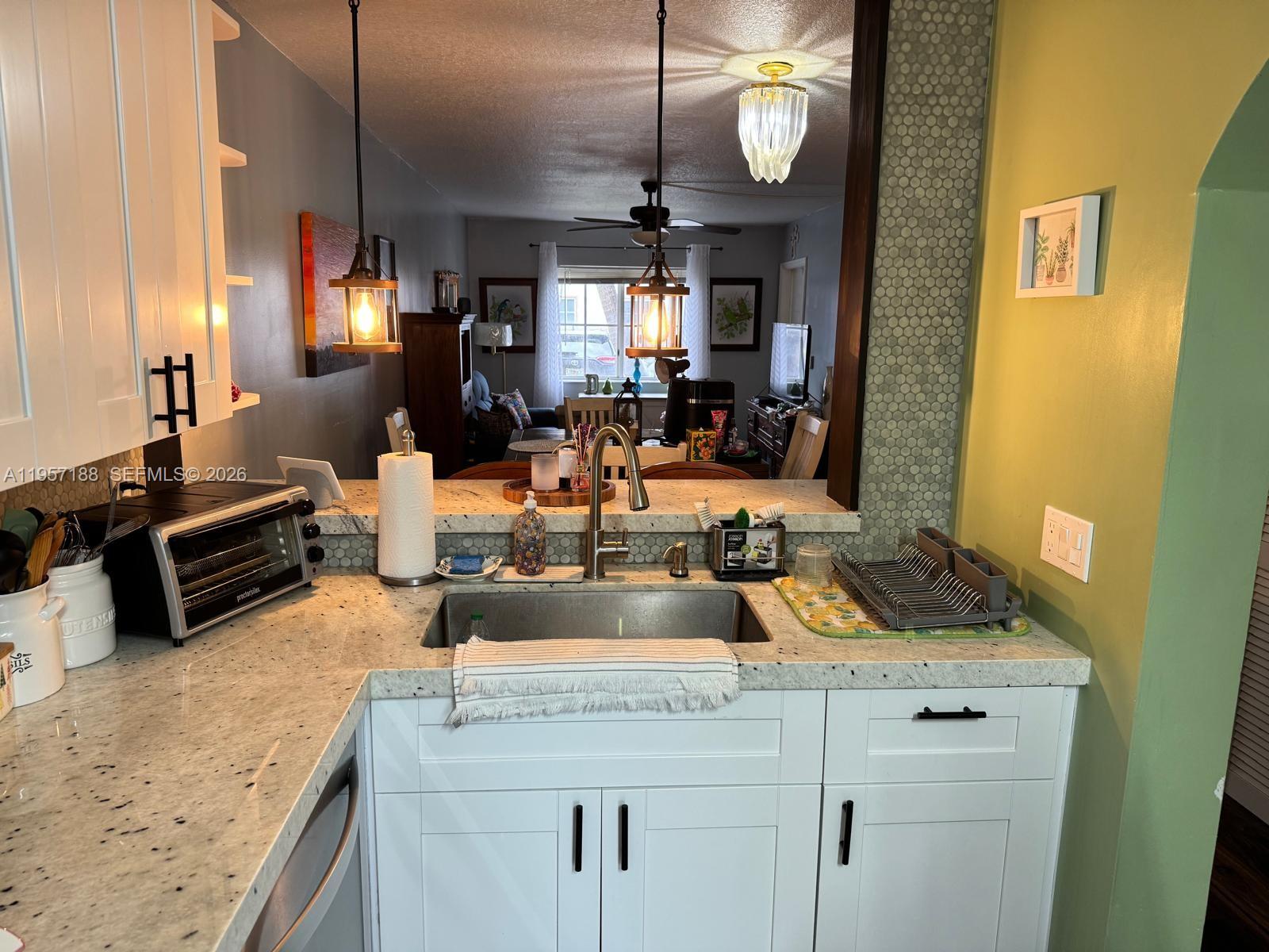 2931 Southeast 12th Road, Unit 10555 Homestead, FL 33035 - Photo 5 of 21 a kitchen with sink and a mirror