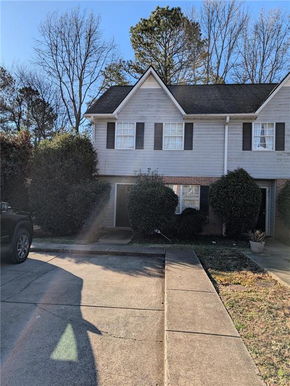 a front view of a house with parking space