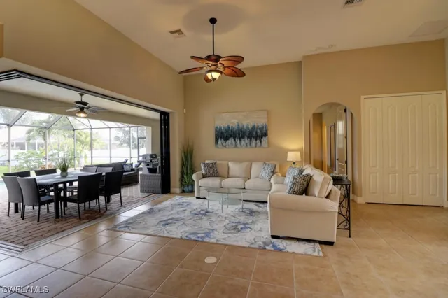 a living room with furniture a window and ceiling fan