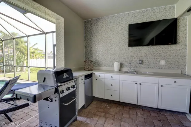 a kitchen with granite countertop a sink and a stove top oven