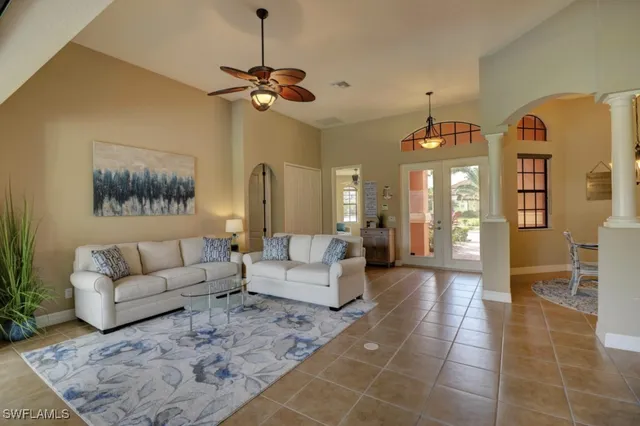 a living room with furniture and a chandelier