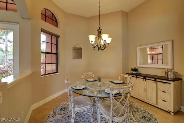 a view of a dining room with furniture and a chandelier