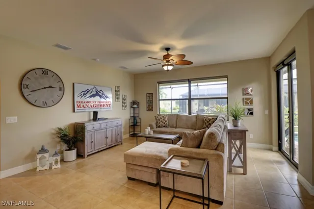a living room with furniture a chandelier and a window