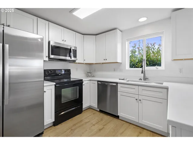 a kitchen with appliances cabinets and a sink