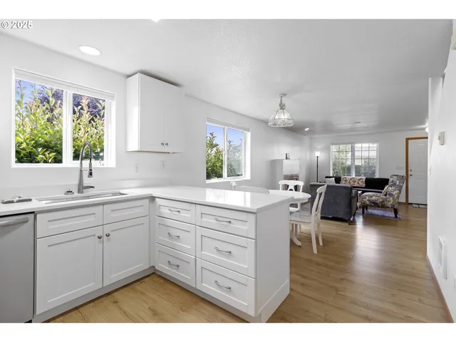 a open kitchen with sink cabinets and wooden floor
