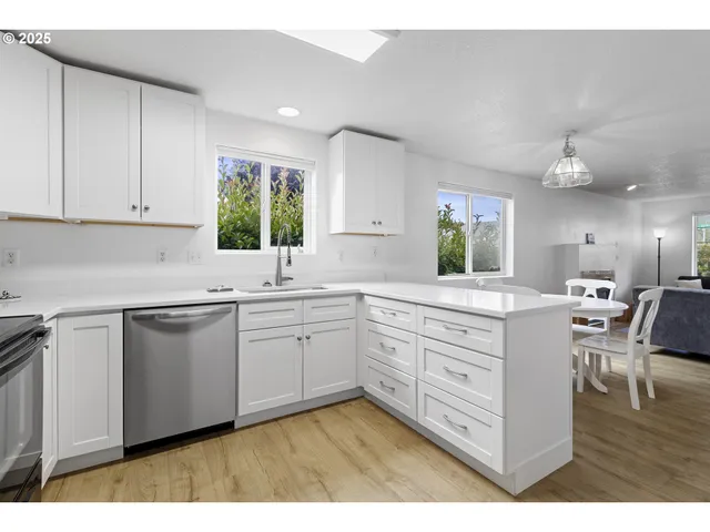 a kitchen with sink cabinets and window