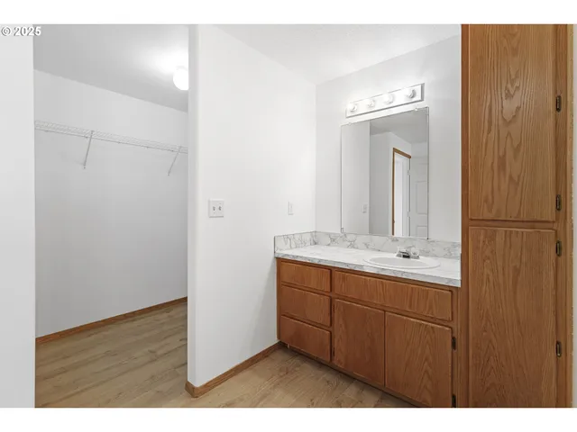 a bathroom with a double vanity sink and a mirror