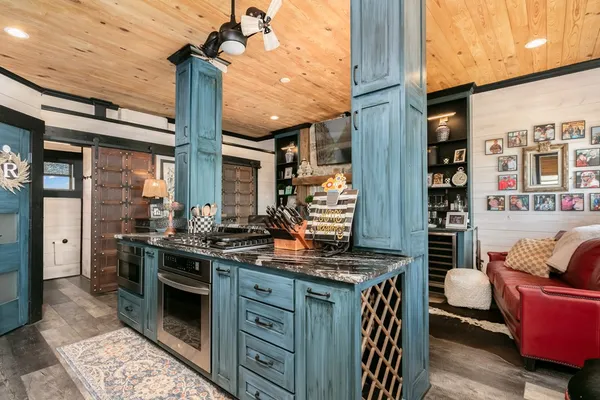 a kitchen with stainless steel appliances granite countertop a stove a sink and a refrigerator