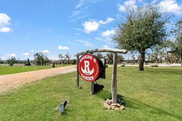 a sign board with a play ground in the back