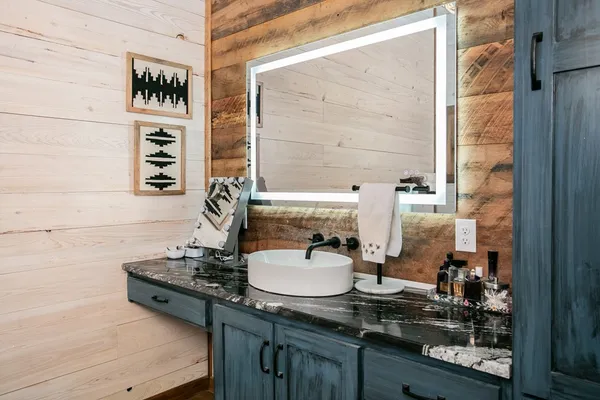a bathroom with a granite countertop sink and a mirror