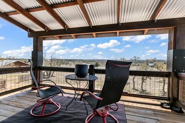 a view of a chairs and table in wooden floor