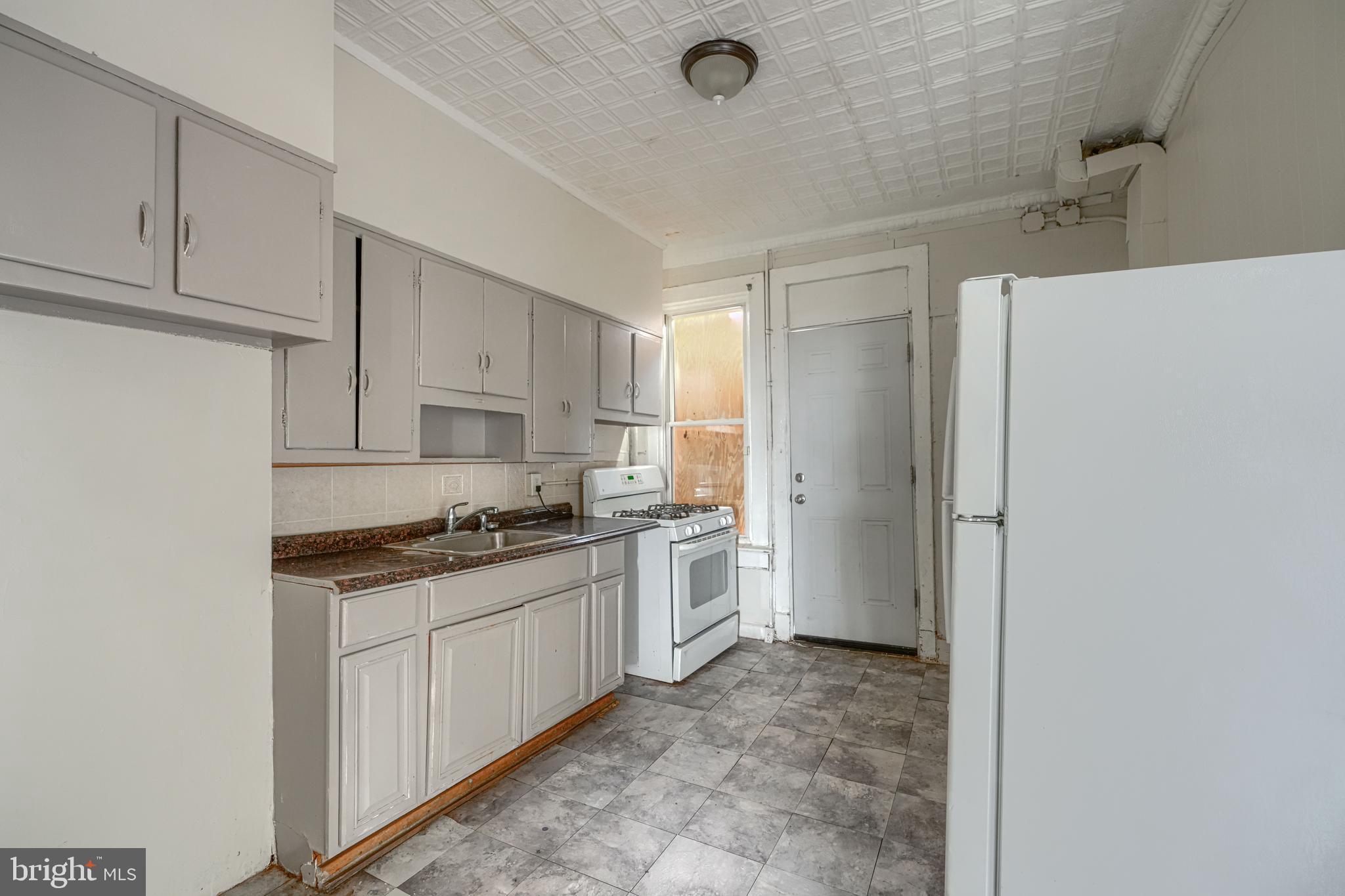 4806 Reisterstown Road Baltimore, MD 21215 - Photo 12 of 34 a kitchen with stainless steel appliances granite countertop a refrigerator and a stove