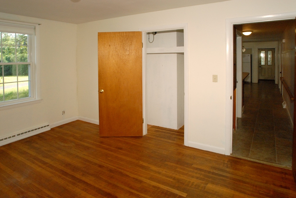 7 Howard Street Milford, MA 01757 - Photo 12 of 22 an empty room with wooden floor and windows