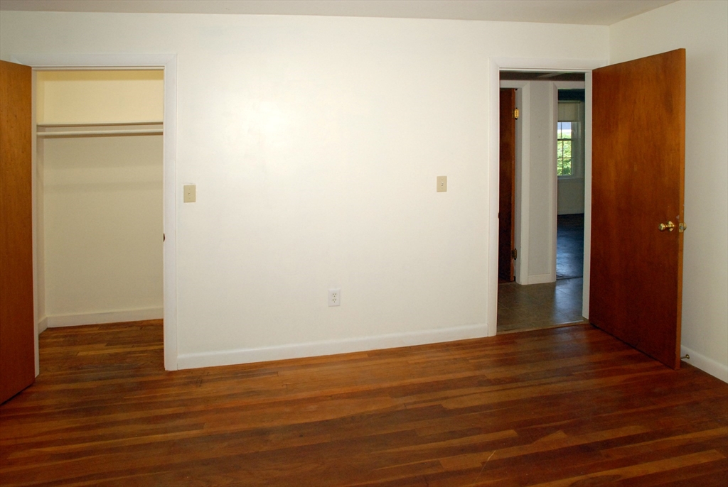 7 Howard Street Milford, MA 01757 - Photo 16 of 22 an empty room with wooden floor and closet