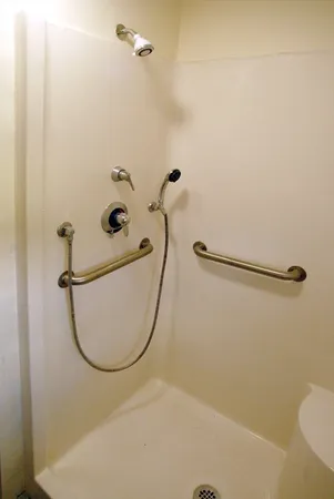 a bathroom with a bathtub a window and a shower