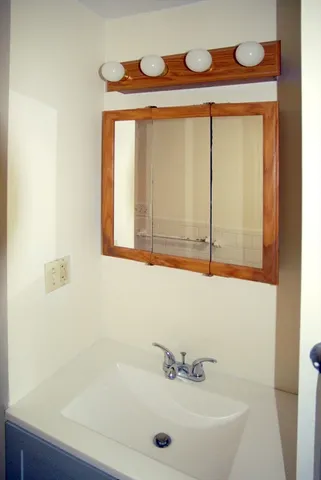 a view of empty room with wooden floor and fireplace
