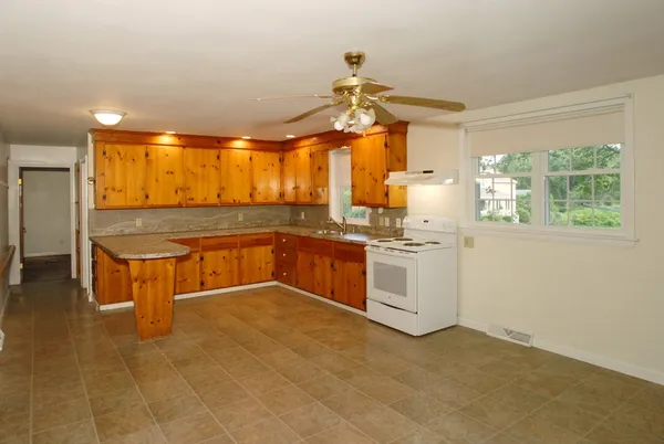 a kitchen with stainless steel appliances granite countertop a sink and cabinets