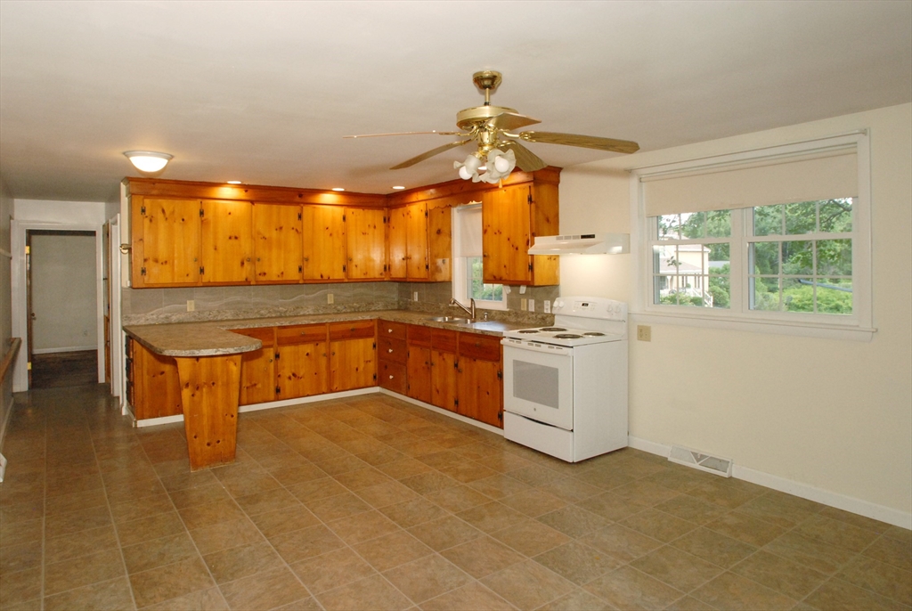 7 Howard Street Milford, MA 01757 - Photo 6 of 22 a kitchen with stainless steel appliances granite countertop a sink and cabinets