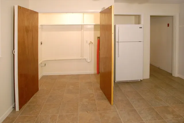 a view of walk in closet with empty racks