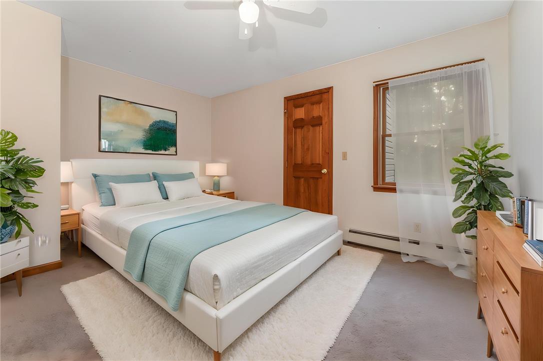 465 Raubsville Road Easton, PA 18042 - Photo 37 of 60 A tranquil bedroom retreat features a neutral palette, warm wood accents, and abundant natural illumination.