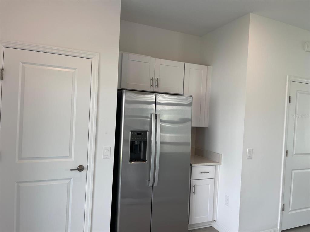 3335 Composition Street Kissimmee, FL 34758 - Photo 11 of 22 a kitchen with metallic refrigerator freezer and a dishwasher
