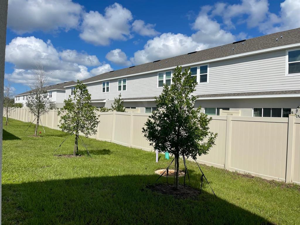 3335 Composition Street Kissimmee, FL 34758 - Photo 17 of 22 a house view with garden space and trees