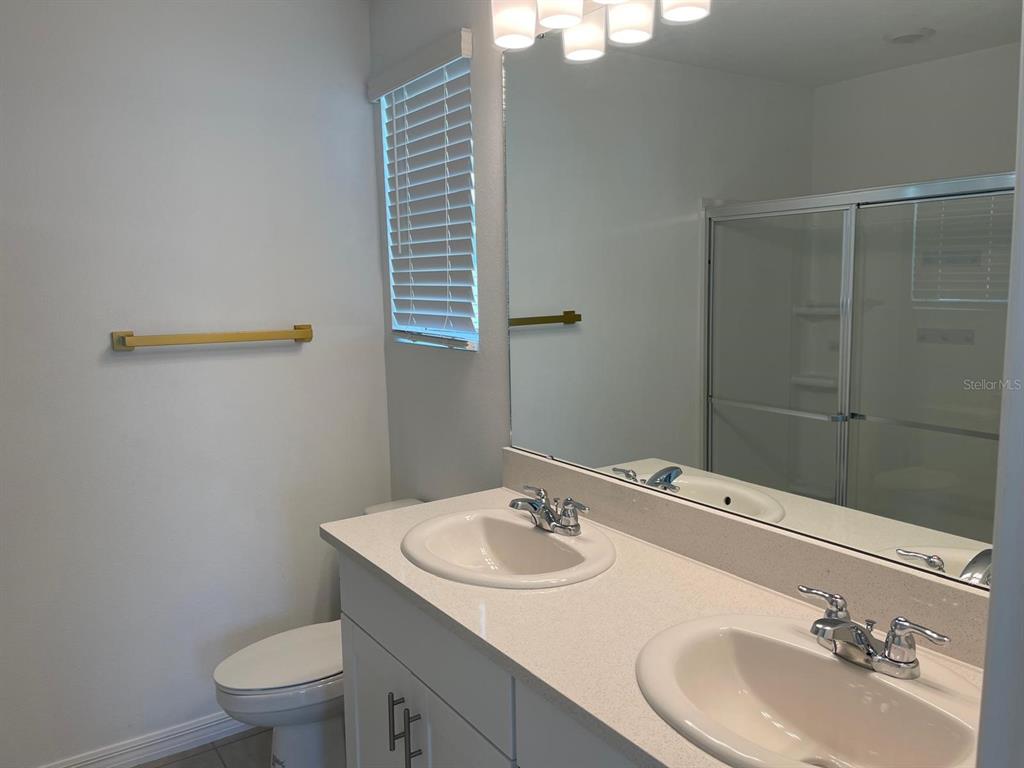 3335 Composition Street Kissimmee, FL 34758 - Photo 18 of 22 a bathroom with a sink toilet and vanity