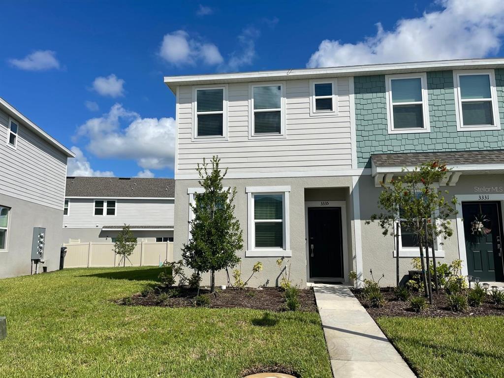3335 Composition Street Kissimmee, FL 34758 - Photo 2 of 22 a front view of a house with a yard and porch
