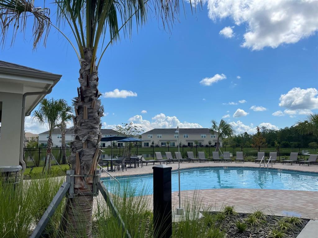 3335 Composition Street Kissimmee, FL 34758 - Photo 3 of 22 a view of a swimming pool with a patio