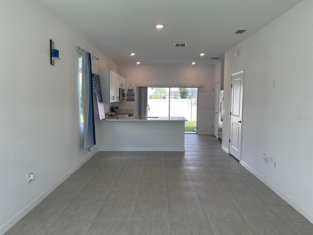 3335 Composition Street Kissimmee, FL 34758 - Photo 9 of 22 a view of a kitchen and a livingroom with a kitchen