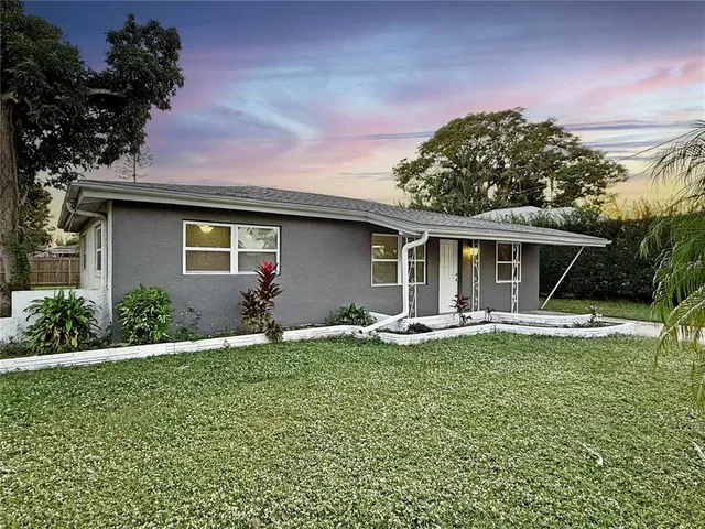 a front view of house with yard and green space