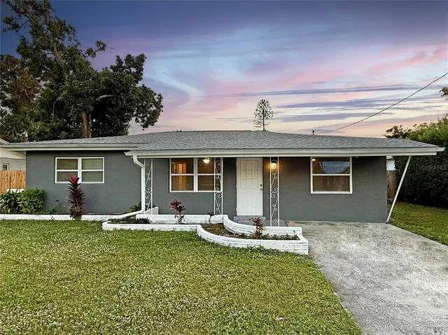 a front view of house with yard patio and green space