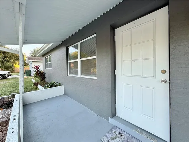 a view of an entryway with a flower garden