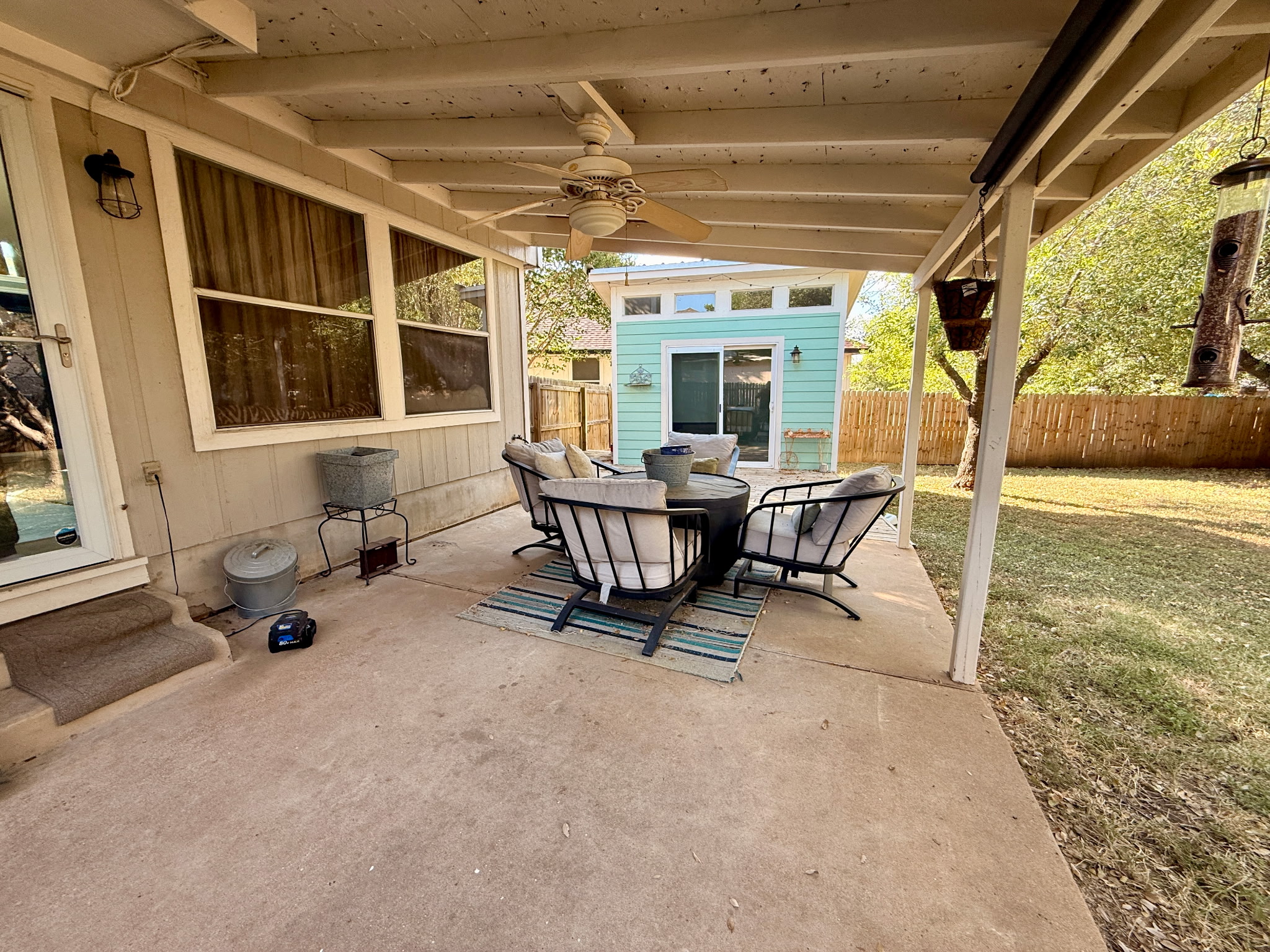 904 Double File Cove Round Rock, TX 78665 - Photo 11 of 25 A spacious covered concrete patio overlooks a grassy backyard with a detached outbuilding.