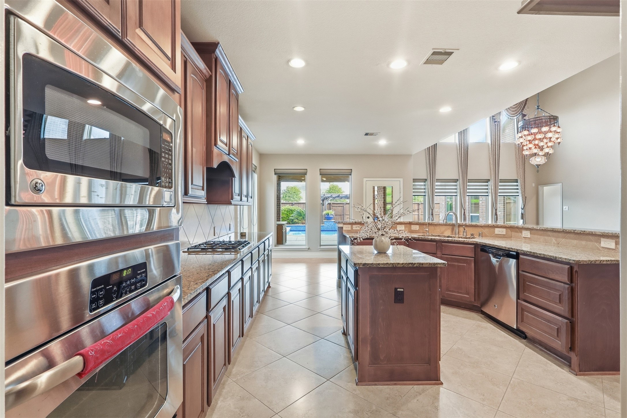 4130 Clover Ridge Lane Sugar Land, TX 77479 - Photo 9 of 48 There's a large island for prep and seating, and the room is filled with natural light from the large windows. A chandelier adds a touch of elegance, and the open layout flows into a bright living area.