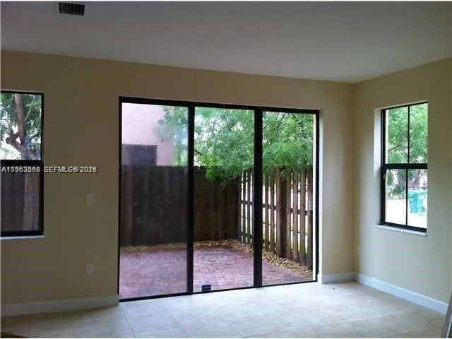 a view of a room has a large window