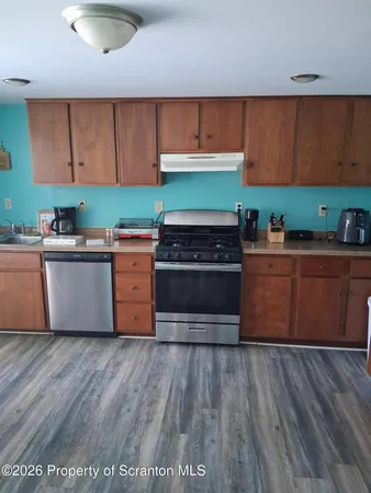 a white refrigerator freezer sitting in a kitchen with stainless steel appliances granite countertop wooden cabinets and a refrigerator