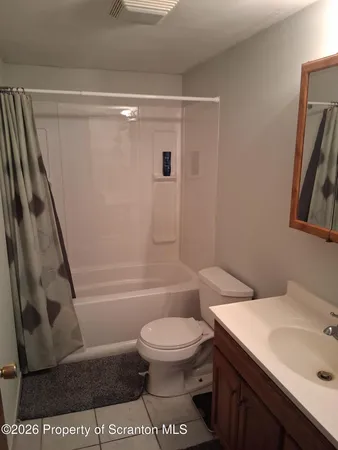a bathroom with a sink vanity and toilet