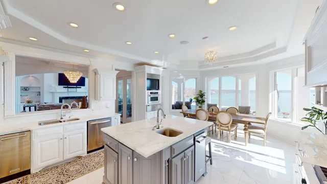 a large kitchen with kitchen island a sink table and chairs