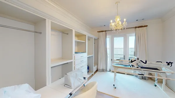 a large bedroom with bed and window