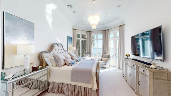 a bedroom with furniture and a flat screen tv