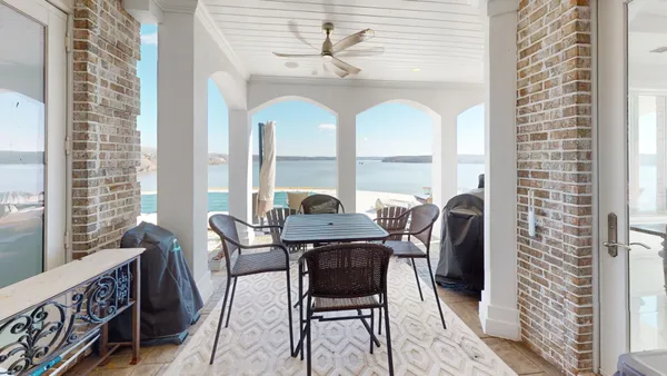 a backyard of a house with table and chairs