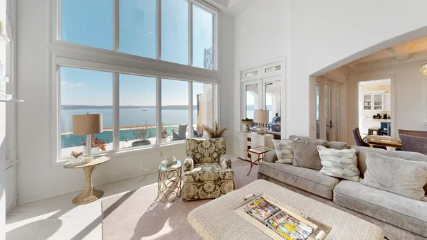 a living room with furniture fireplace and a large window