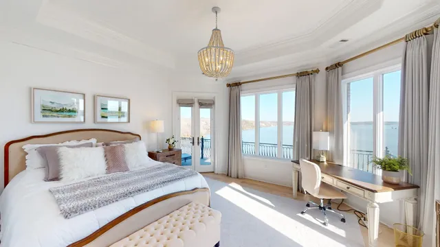 a spacious bedroom with a bed and a flat screen tv