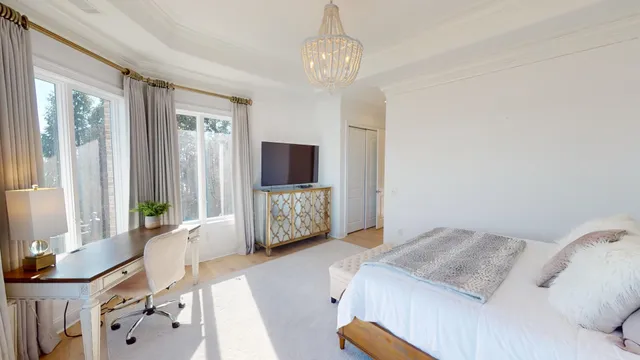 a room with chandelier furniture and a large window