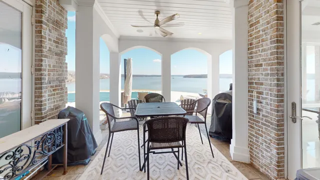 a view of a lake with two chairs and a table